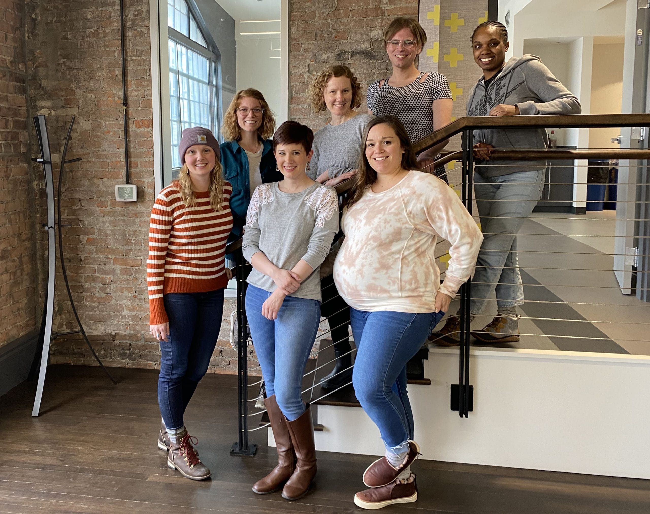 a group of Nutshell employees are posing for a picture on a set of stairs