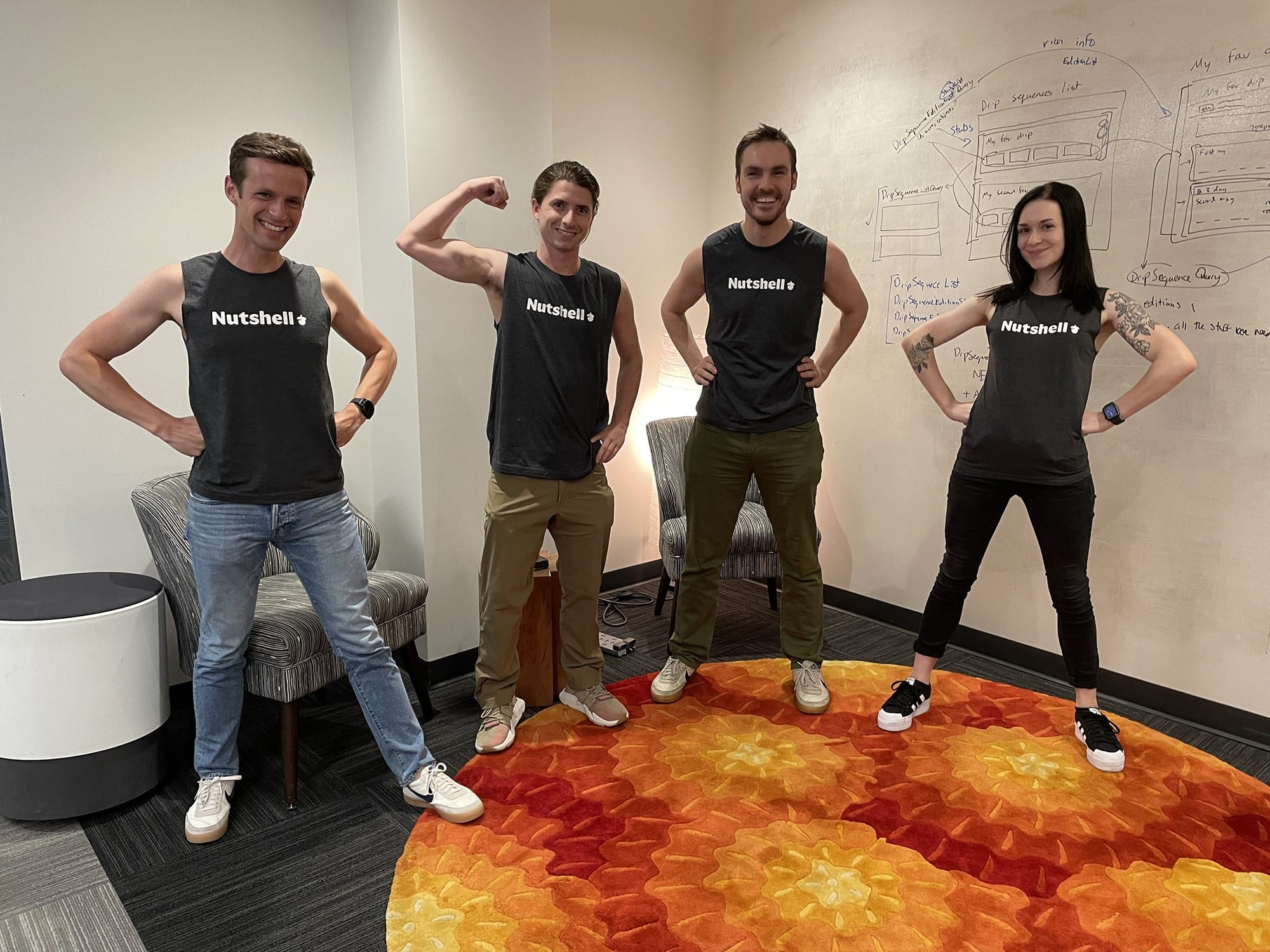 Four Nutshell members wearing shirts that say Nutshell