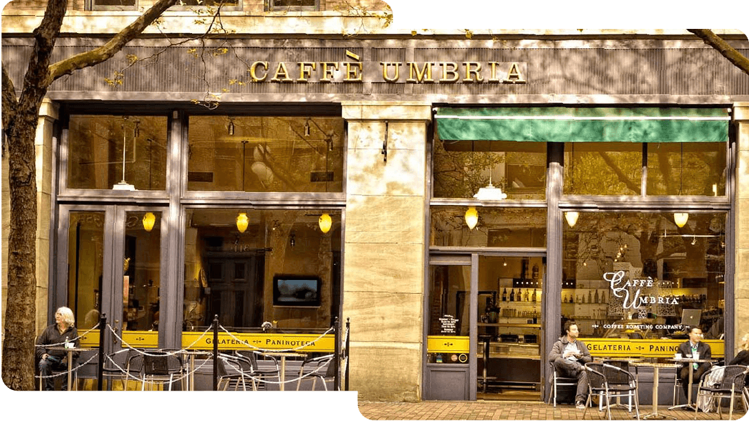 the outside of Caffe Umbria with people sitting outside